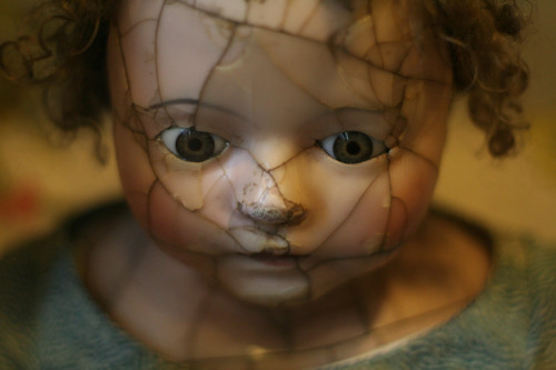 The face of a creepy broken porcelain doll