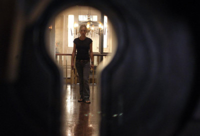 Caroline walking down the hallway in The Skeleton Key