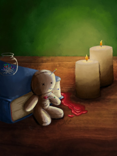 Voodoo doll resting against a book