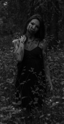 Vampire woman walking through the forest