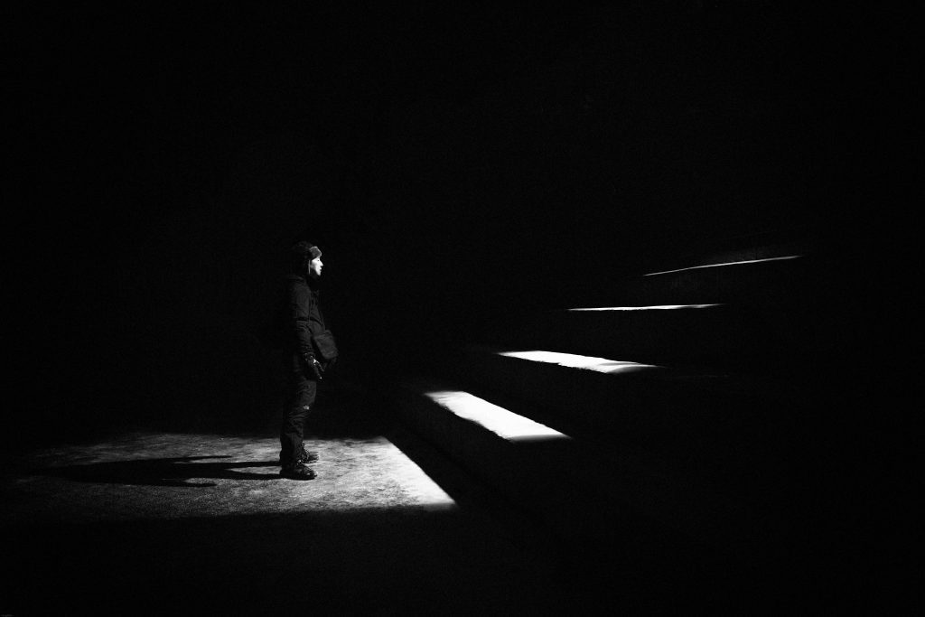 Staring up the stairs, in the darkness