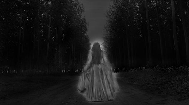 Ghost woman walking through the forest