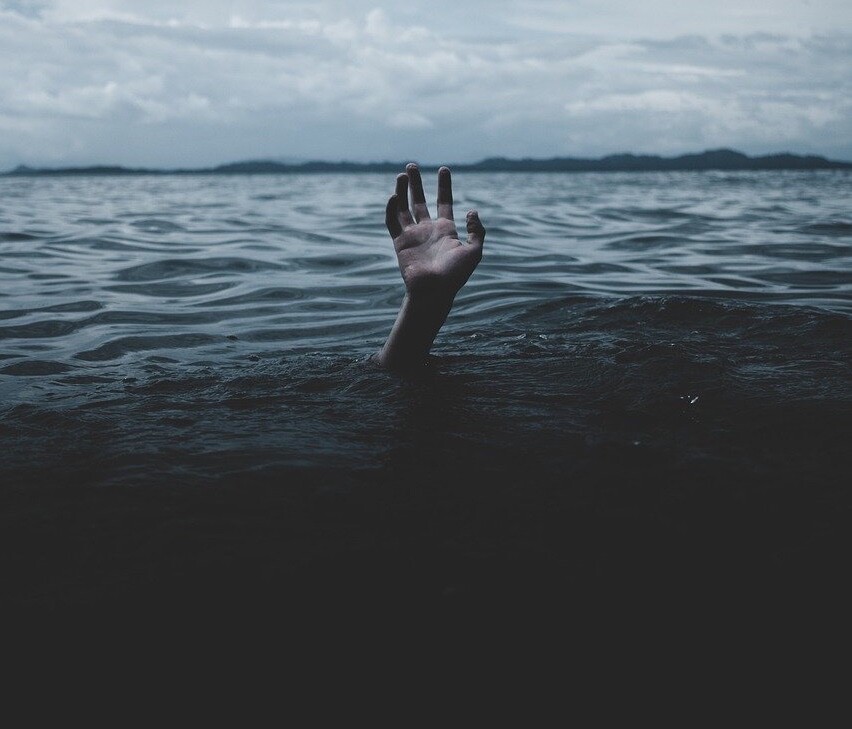 Dark water with hand coming out