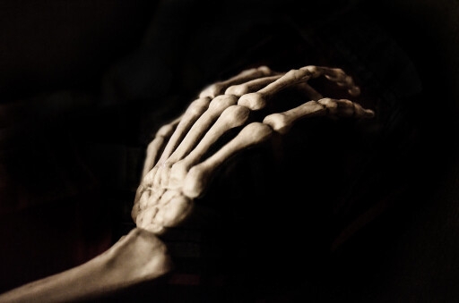Skeleton hand reaching in the dark