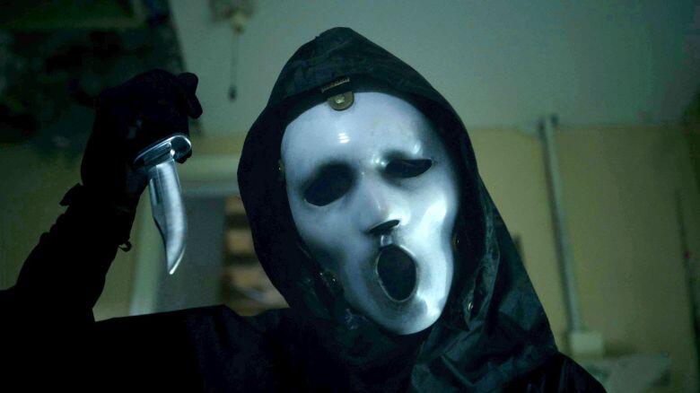 Scream mask from MTV series with a man holding a knife
