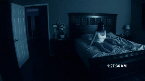 Woman on bed in Paranormal Activity found footage horror movie